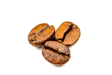 Isolated coffee beans. Three seeds on a white background.