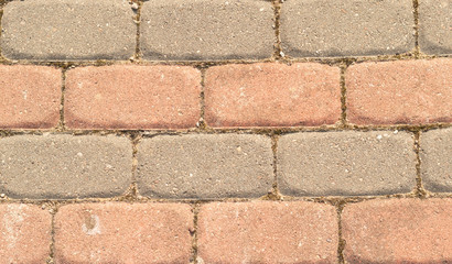 Cobbled surface with paving stones in different shades - top view.Natural stone pavement. Exterior floor covering.