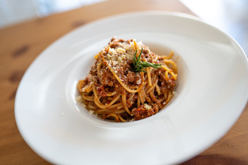 Spaghetti bolognese served on a white plate