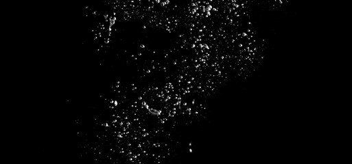 Blurry images of real soda bubbles floating and splashing up in black background which represent freshness of carbornate drink or sparkling water and shoot from realistic water moving not 3D making