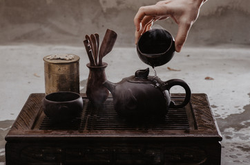 Cropped shot of woman pouring tea in traditional chinese teaware