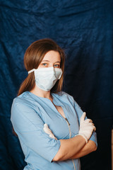 doctor in a mask on a blue background. Coronavirus 2020