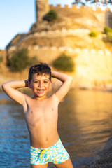 Fototapeta premium Little boy with swimmsuit on the beach