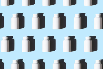white medicine bottles pattern on blue background