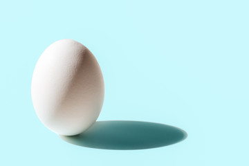 White egg with shade on blue background