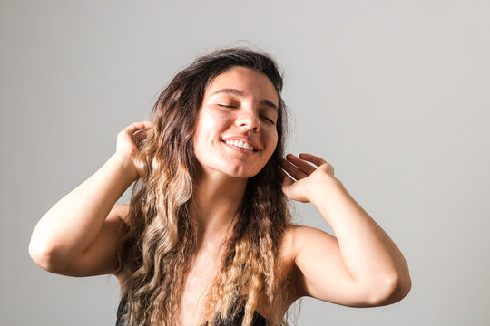 Portrait Of A Young Cheerful Woman With Freckles Skin Green Eyes And Curly Hairs In Black T-shirt Smiling. Natural Beauty And Body Positive