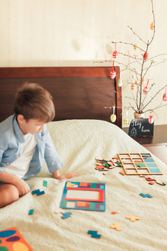 Boy playing home while coronavirus quarantine. Small DoF image, focus on Easter decoration.