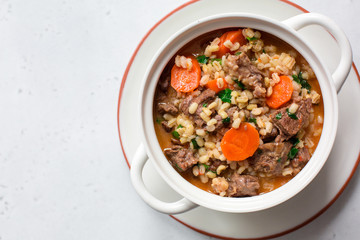 Homemade beef and barley soup. White background. Copy space.