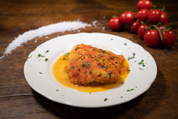 traditional Tuscan Baccalà alla livornese with its sauce and parsley from the table of an old typical tavern