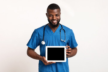 Black friendly doctor demonstrating empty digital tablet screen