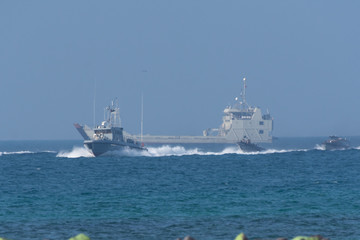Navy warship fleet speed through the gulf water towards shore in combat and war. Military navy...
