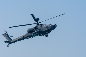 Military chopper in war flies through the sky. Military concept of power, force, strength, air raid.