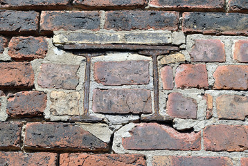 Old Brick Wall with Remains of Rusty Steel Beam 