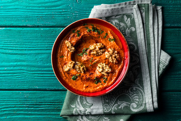 Roasted red bell pepper spread - muhammara - in a red bowl