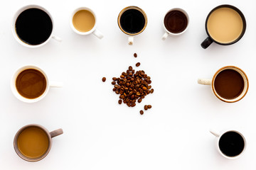 Many cups of coffee on white background top view