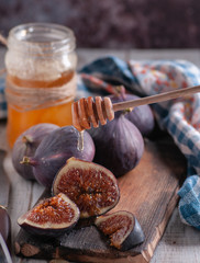 still life of figs with honey on a wooden basis