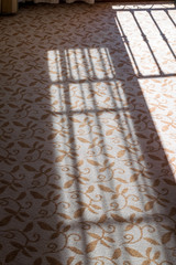 Rail shadow on a carpet.