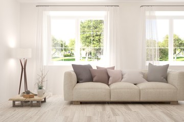 White living room with sofa and summer landscape in window. Scandinavian interior design. 3D illustration