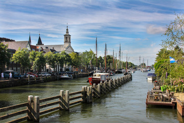 Muiden Harbor with a fence in the middle and a few boats