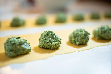 Fresh homemade italian pasta ravioli with ricotta and spinach. The process of cooking.