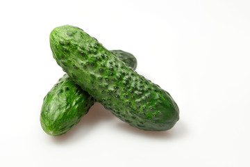 Green fresh cucumber isolated on white backround .