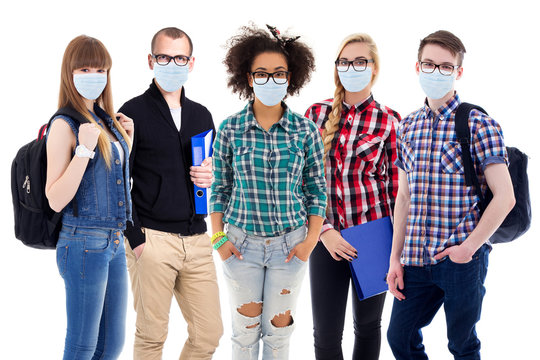 pandemic, health care and education concept - large set of teenagers or students in protective masks standing isolated on white
