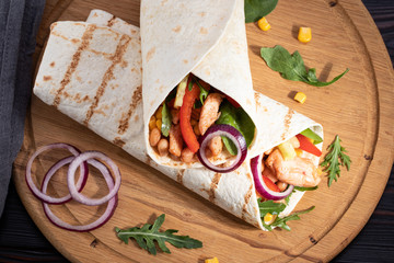 Mexican burrito with chicken, pepper and beans. Top view