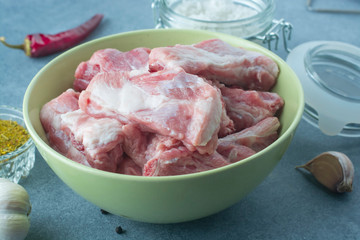 Raw meat. Pork ribs in a ceramic bowl.