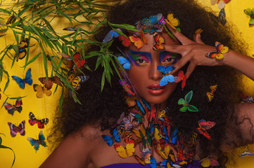 Fototapeta na wymiar beautiful african girl surrounded by butterflies