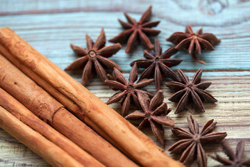 Cinnamon sticks and aniseed stars close up on a wooden table