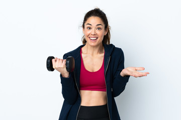Sport woman making weightlifting over isolated white background with shocked facial expression