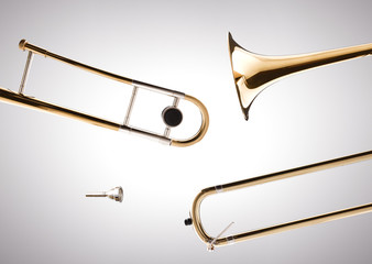 Trombone disassembled with white gradient isolated background