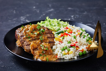 fried hamburger steaks with onion gravy and salad