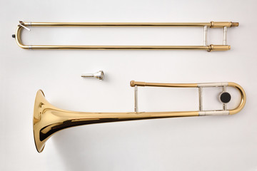 Trombone disassembled on white table top