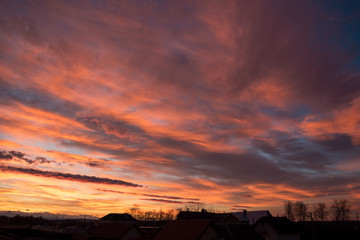 Fototapeta premium Sunset. Evening sky, clouds are painted in different bright colors: blue, red, orange, purple, pink, yellow.