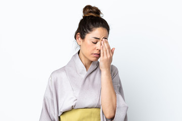 Woman wearing kimono over isolated background with headache