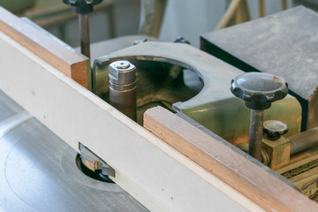 Close up shot of a carpentry machine in action. Woodworking concept, sawmill interior,  lumber export service.
