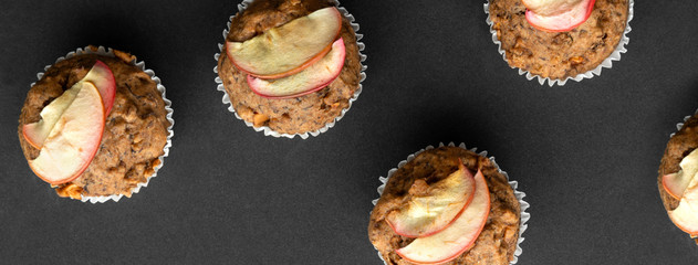 Top view flat lay homemade vegan banana muffins. Vegetarian egg-free bakery on dark background.