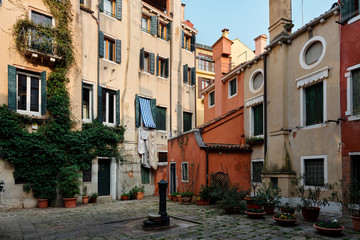 Fototapeta na wymiar Venice Italy - September 19, 2020: Typical neighborhood at heart of Venice with colored buildings 