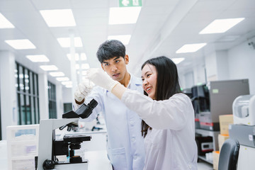 Two medical scientist looking at test tube. select focus in young female scientist