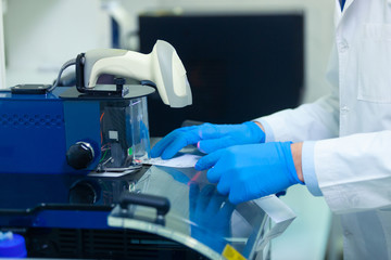 DNA laboratory. The expert puts the human DNA into the database using advanced laboratory technologies