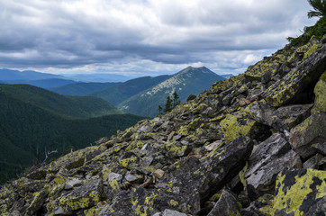 Landscape with a blue sky and white clouds above the Carpathian mountains, near mount Dovbushanka. Summer Gorgany mountain ridge view. Ukraine 