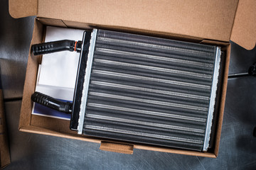 New car cooling radiator in box with documents