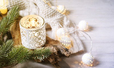 Cosy and soft winter background, knitted sweater and lights