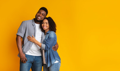 Fototapeta premium Portrait of happy black couple of lovers embracing each other