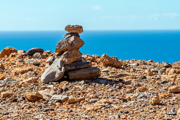 cairn on a rock against the background of the sea