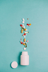 Antiviral pills, antibiotics, capsules, vitamins, healthy lifestyle concept, medical background with place for text top view