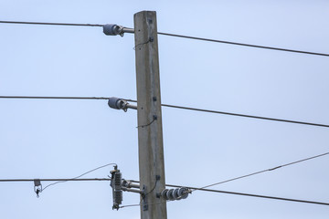 Concrete Power Pole and Electric Lines against a Blue Sky