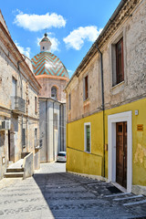 Fototapeta na wymiar A narrow street between the houses of a medieval town in the Calabria region in Italy