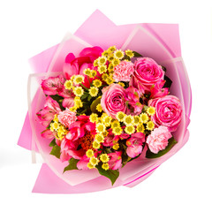 Pink bouquet with yellow chamomile, and pink roses in pink paper